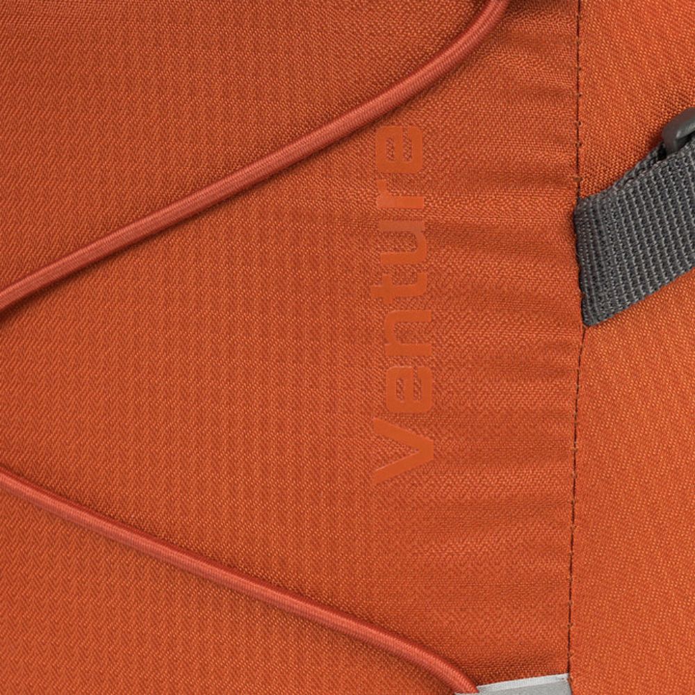 Close-up of Venture logo detail on the rust fabric.