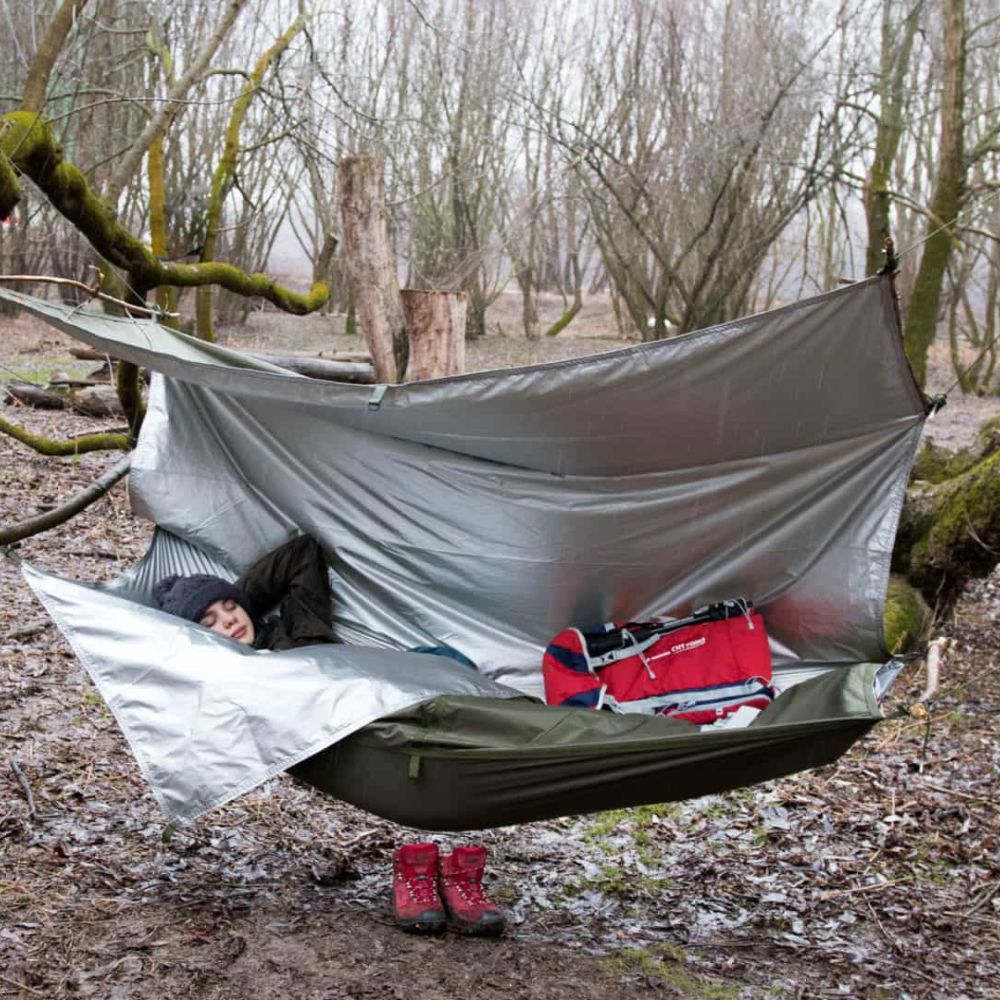 Child sleeping in a hammock made from a thermo-tarp.
