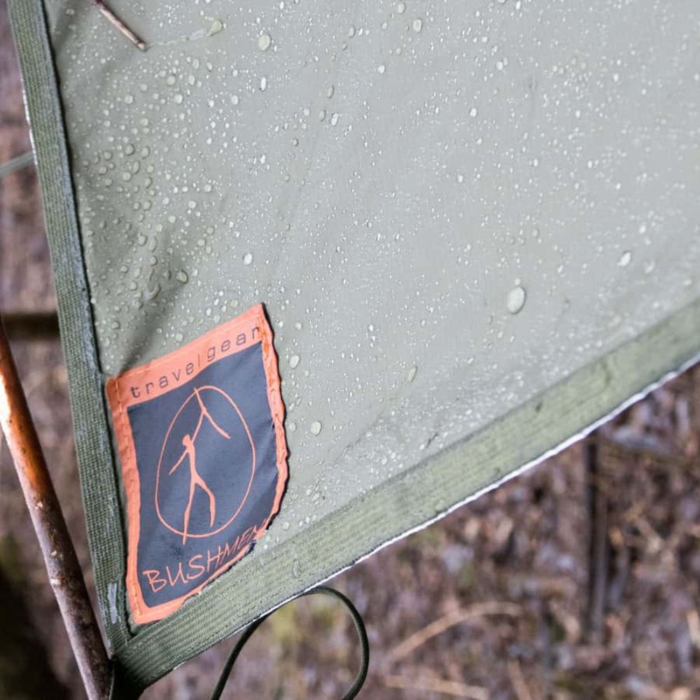 Thermo-tarp corner with Bushmen logo and water droplets.