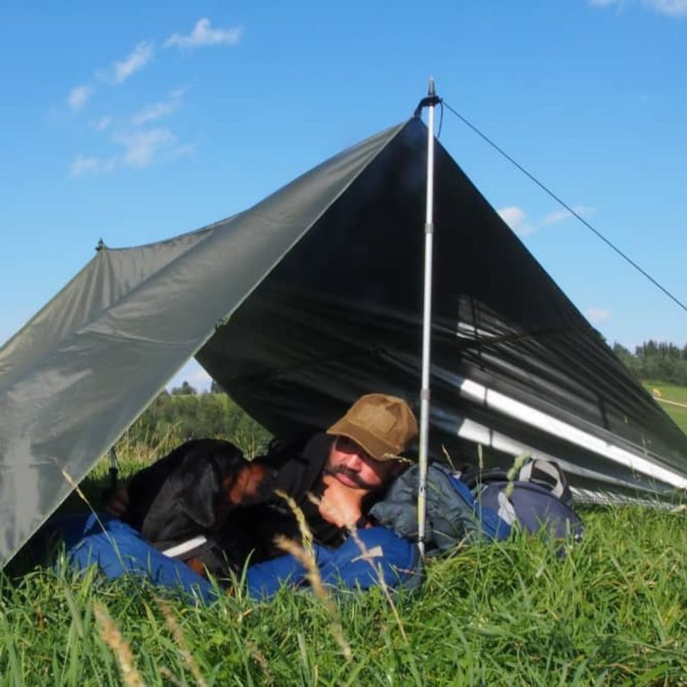 thermo-tarp setup as tent in open field.