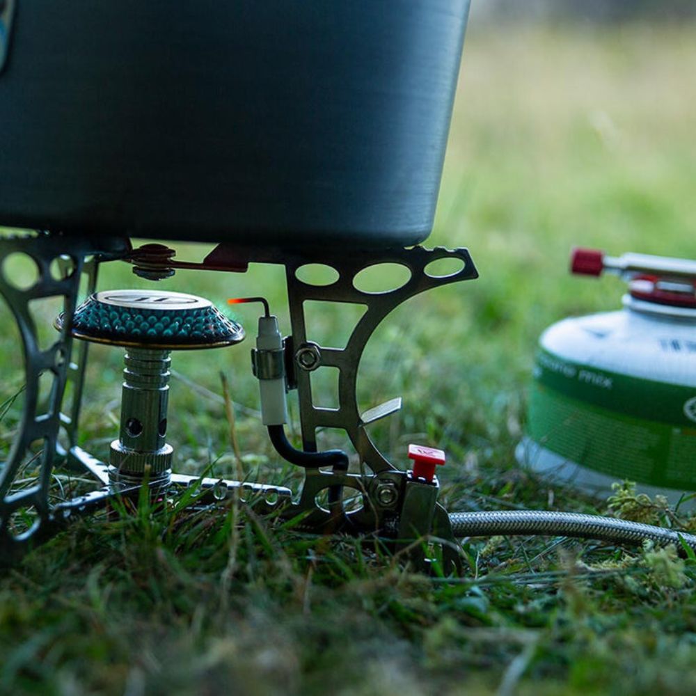 Triplex Compact Camping Gas Stove with attached gas canister.