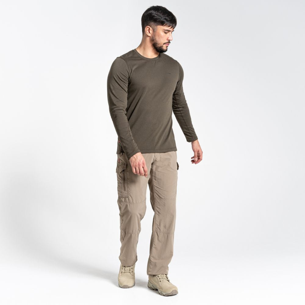 Model wearing pebble-colored Men's NosiLife Cargo II Trousers with a relaxed fit.