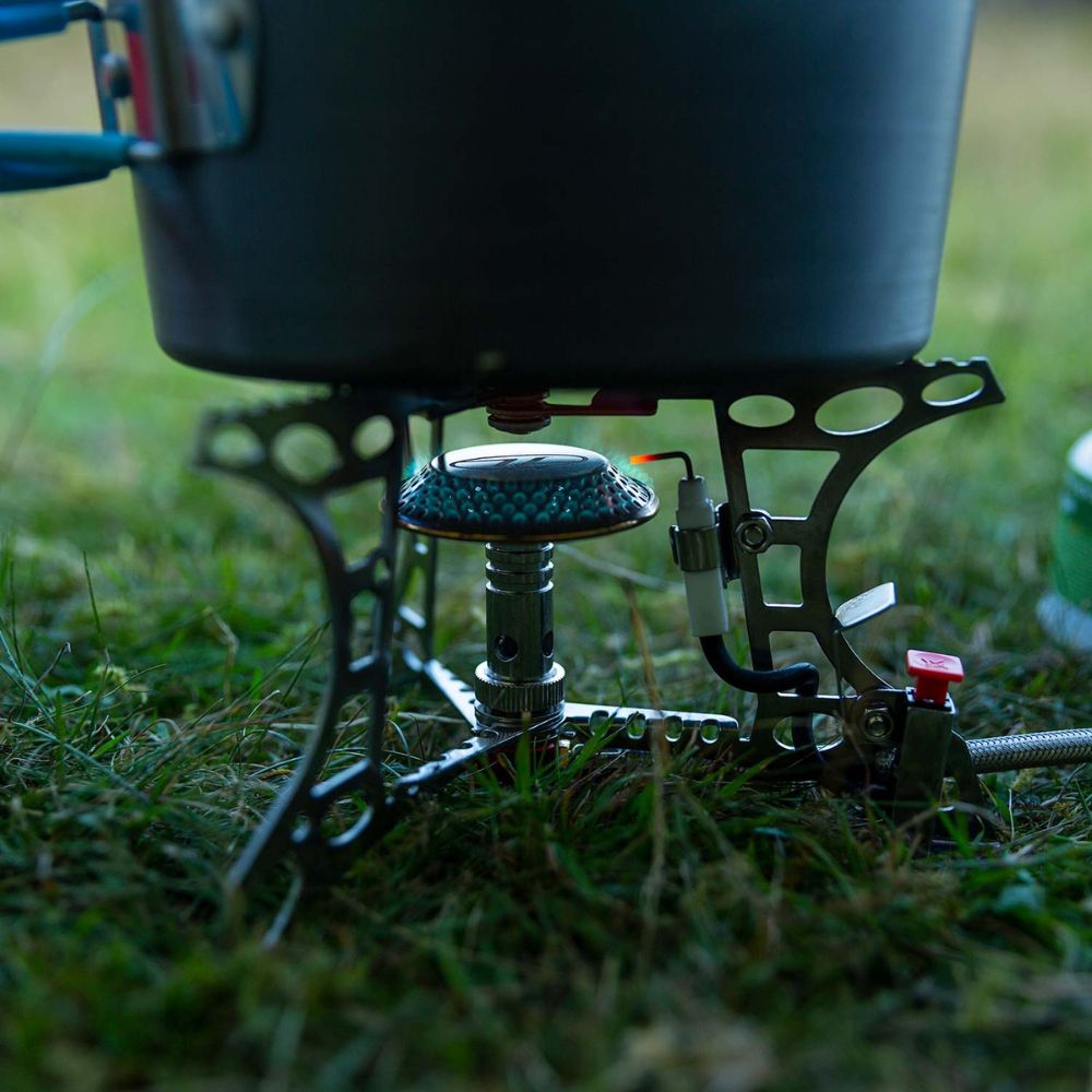 Side view of Triplex Compact Camping Gas Stove while cooking.